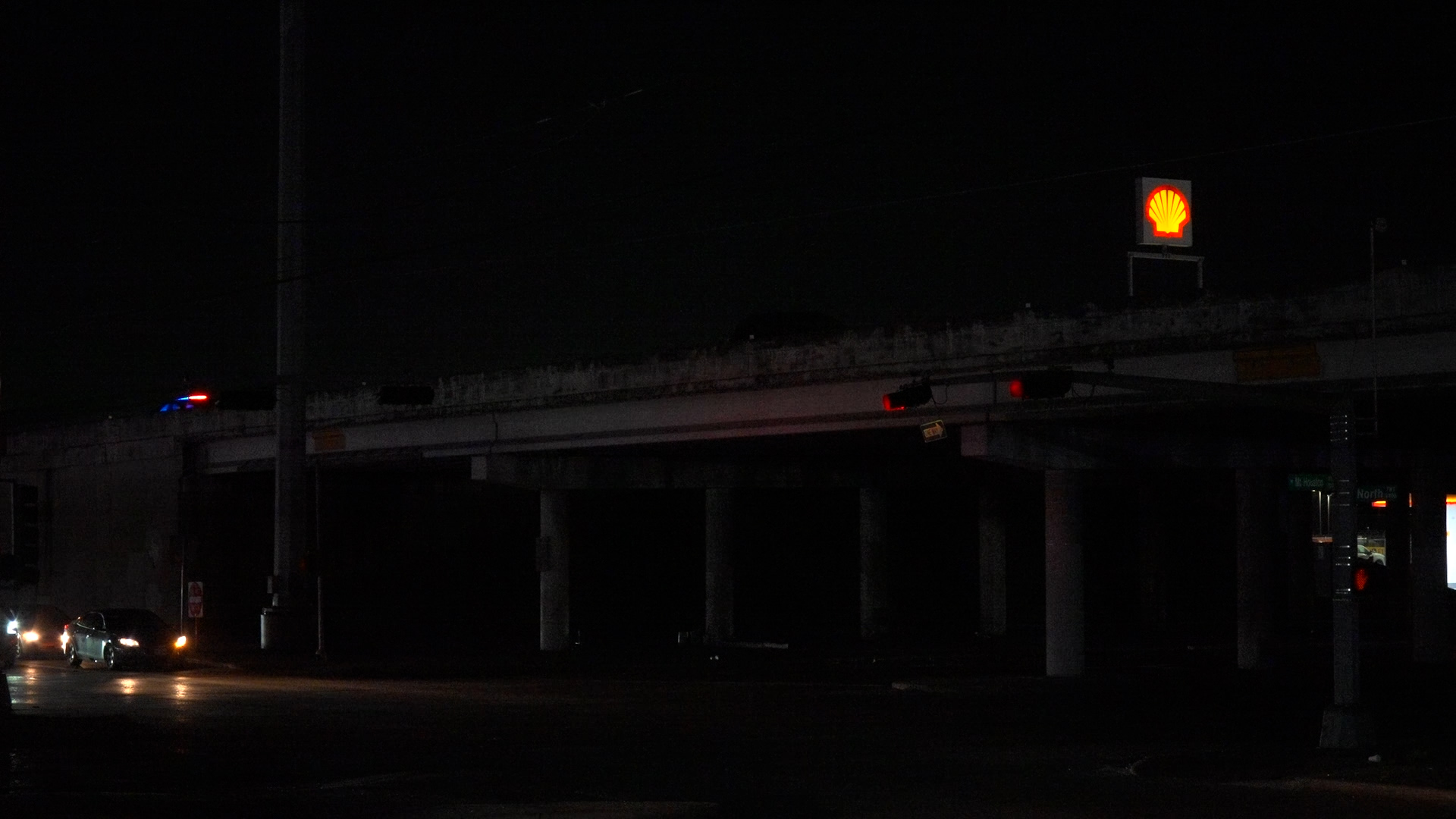 Woman struck while pushing vehicle on North Freeway overpass, suspect ...